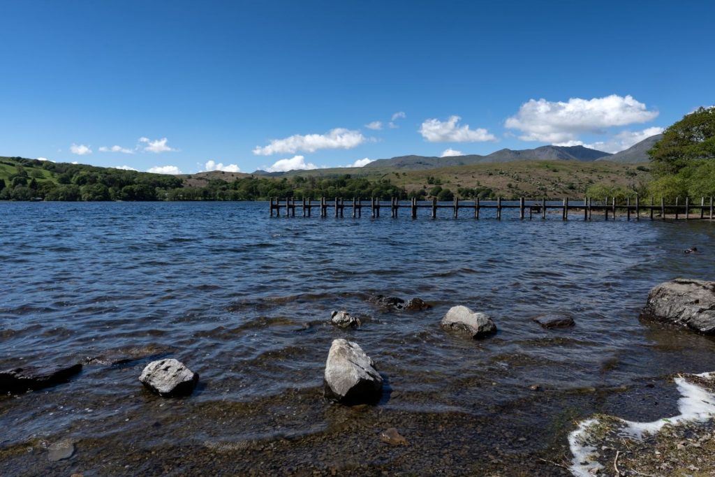 Rocky shore and wooden jetty at Coniston Water