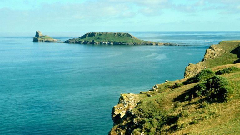 Gower Peninsula coastline with cliffs and blue sea, a destination for kayaking in South Wales