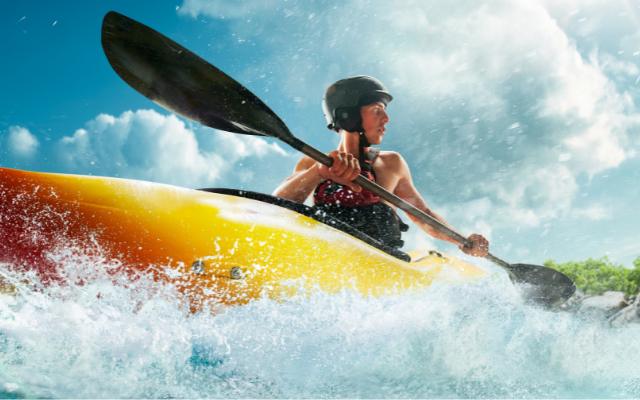 A paddler propelling a kayak across the water