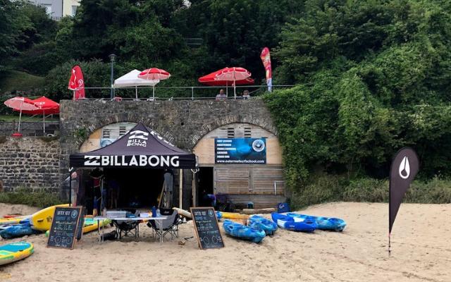Kayaks outside a beach watersports hire hut